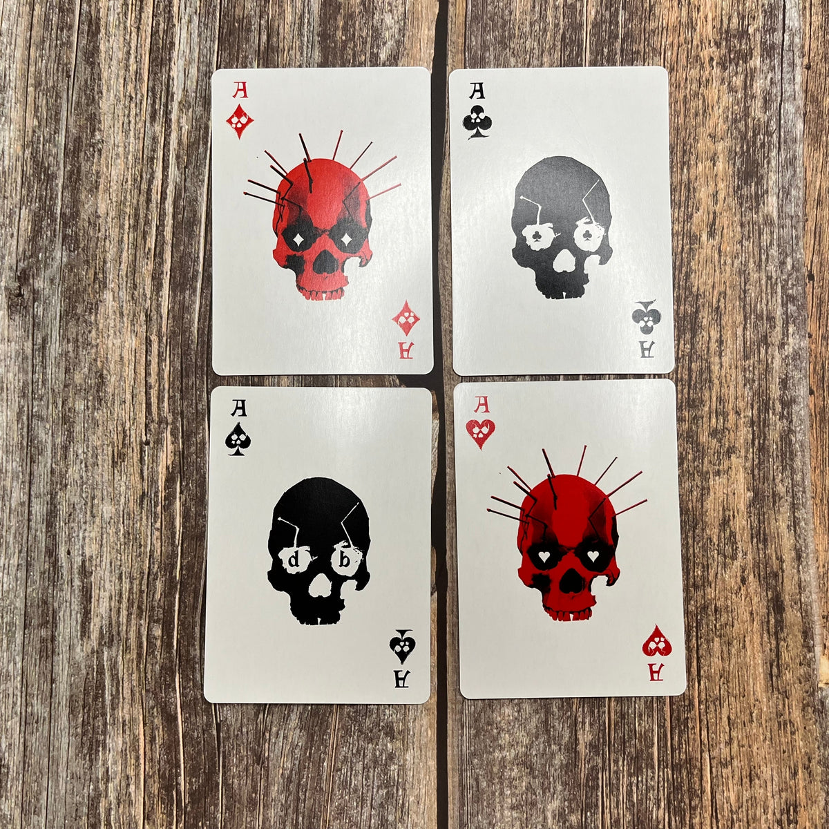 Each of the Ace court cards from a red and black skull poker deck