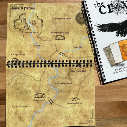 Worn fantasy map book on a wooden surface with 'The Craw Atlas' cover.
