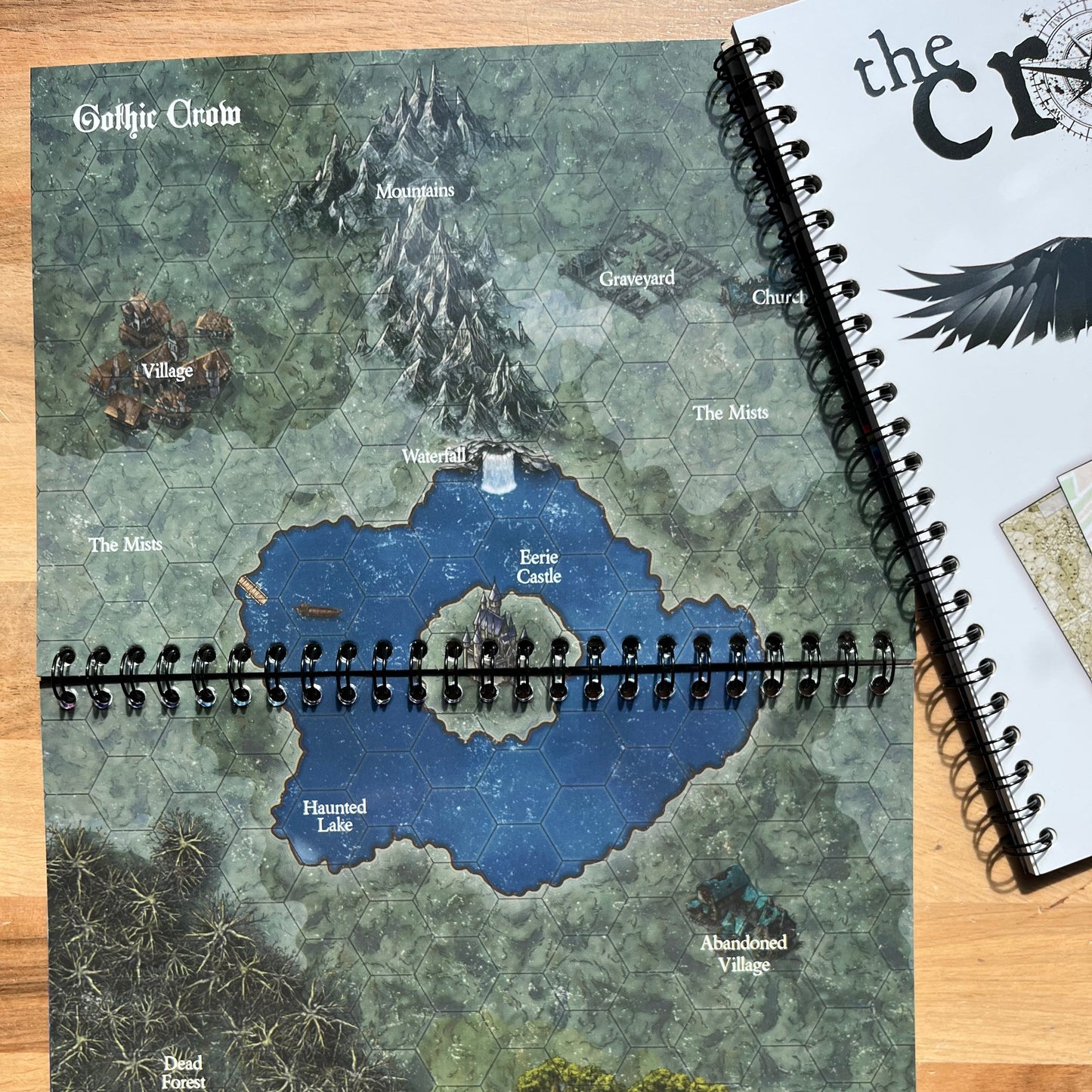 Map notebook with a detailed map on a wooden surface