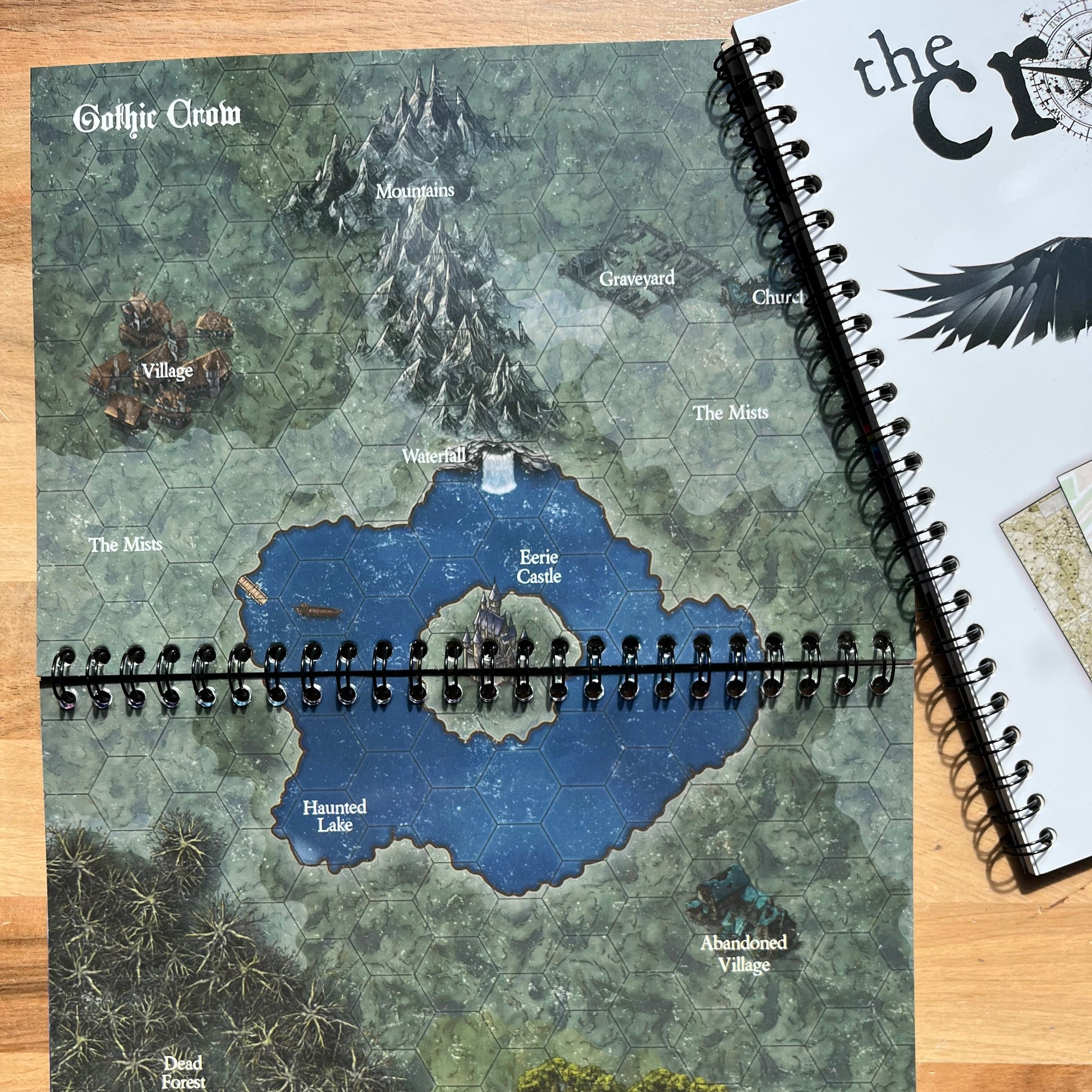 Map notebook with a detailed map on a wooden surface