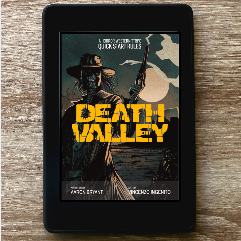 A black tablet device displaying the book cover for 'Death Valley' by Aaron Bryant and Vincenzo Ingenito, placed on a light brown wood-grain surface.